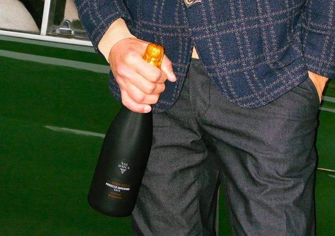 uomo con bottiglia di vino Val d'Oca